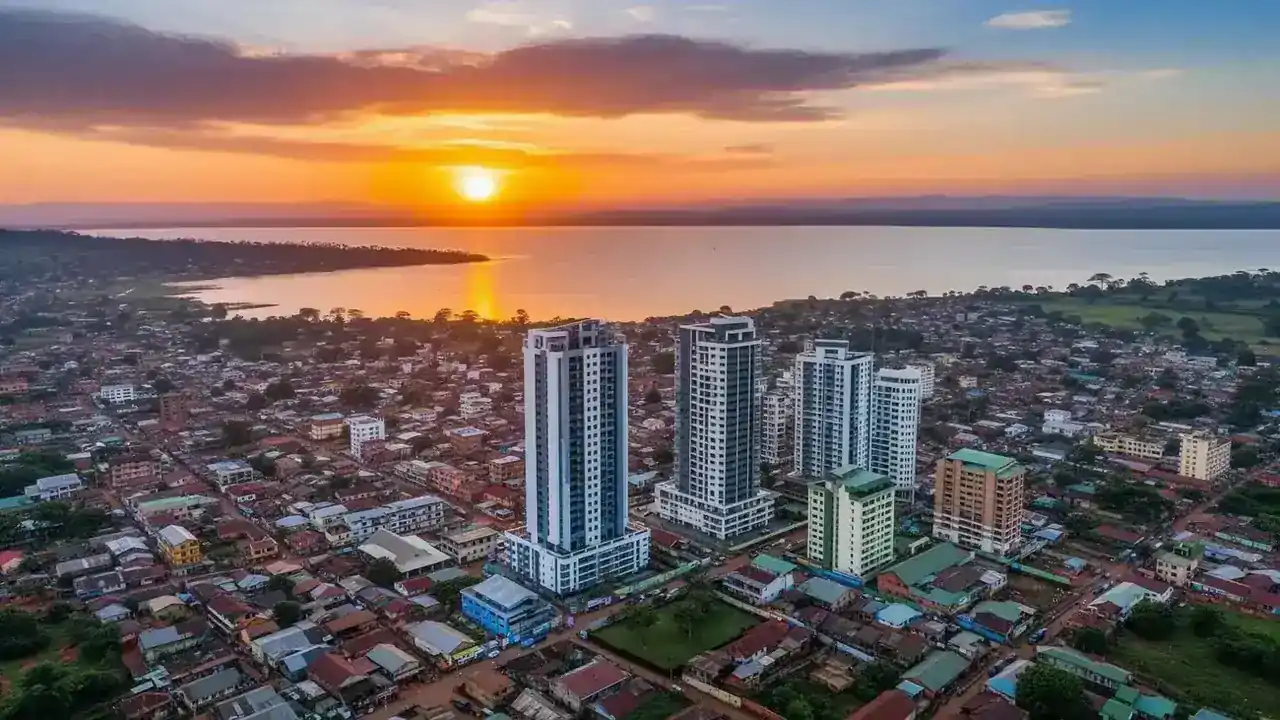 Urban skyline beside a lake at sunset